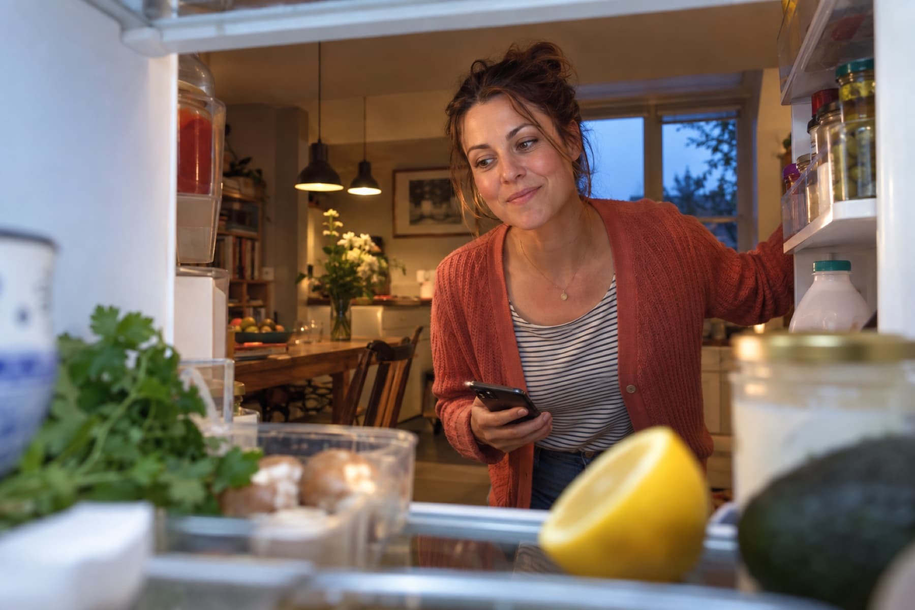 A parent looking into her fridge for dinner inspiration